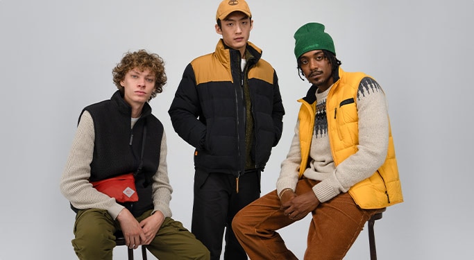 Image of three young men in black and yellow Timberland outfits, facing the camera.