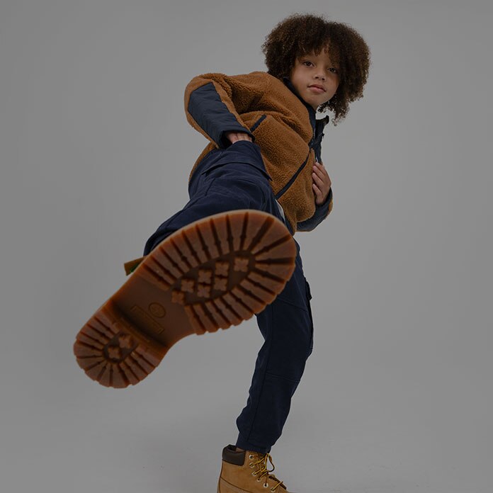 Timberland Holiday Gift Guide image of a kid wearing Timberland apparel and boots