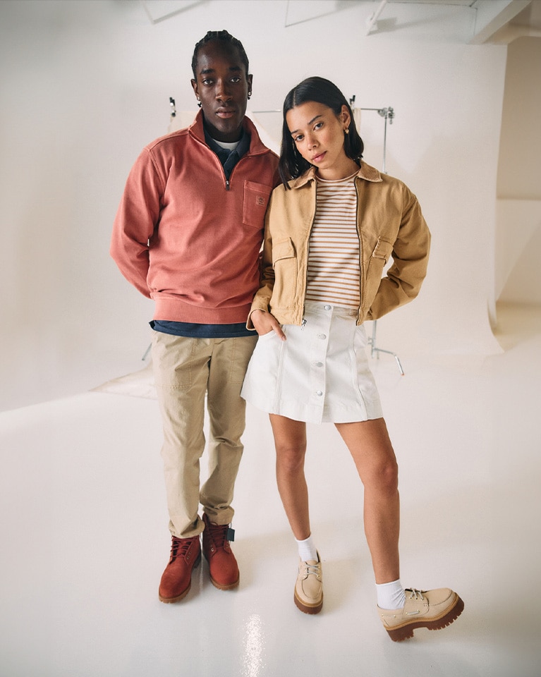 Image of a man and a woman looking at the camera wearing Timberland clothing and shoes